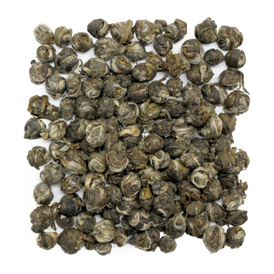 Noteworthy Selections Jasmine Pearl Loose Leaf Tea rolled in tiny balls on white background.